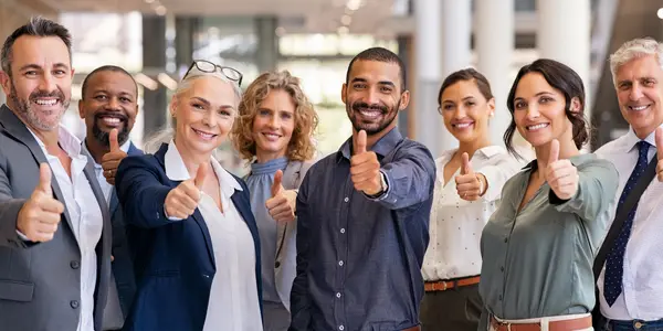 Diverse business team giving thumbs up