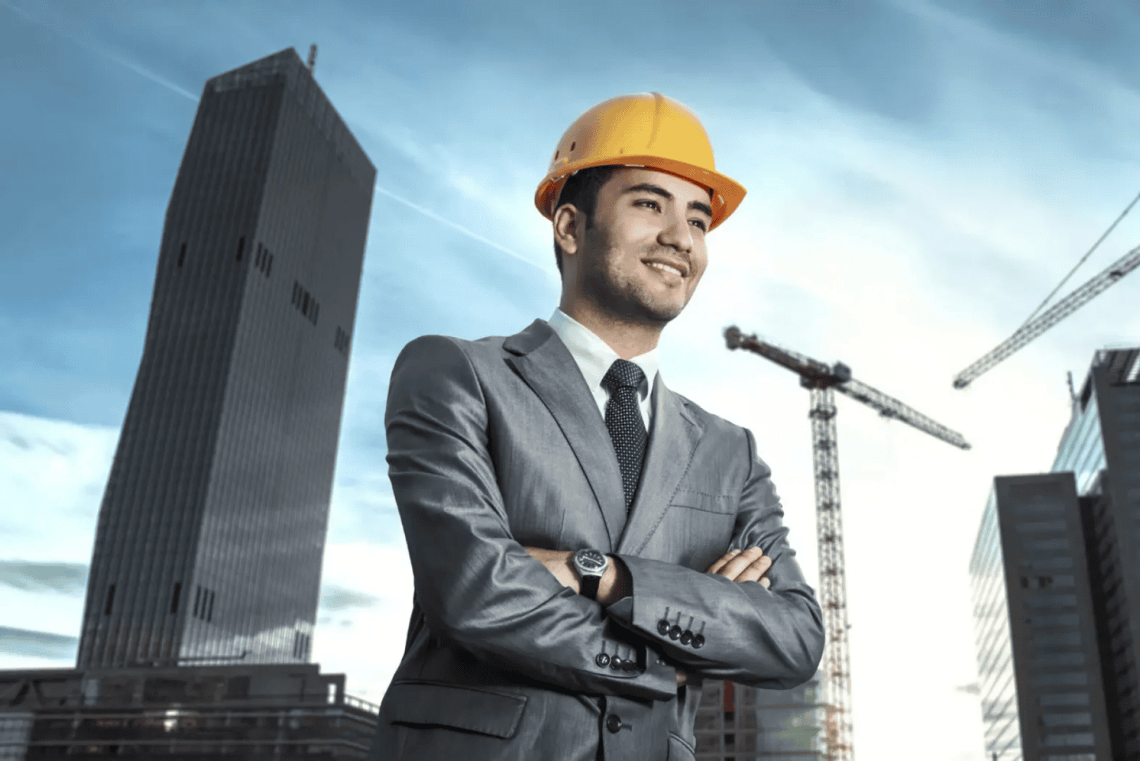 Smiling engineer with helmet, urban background.