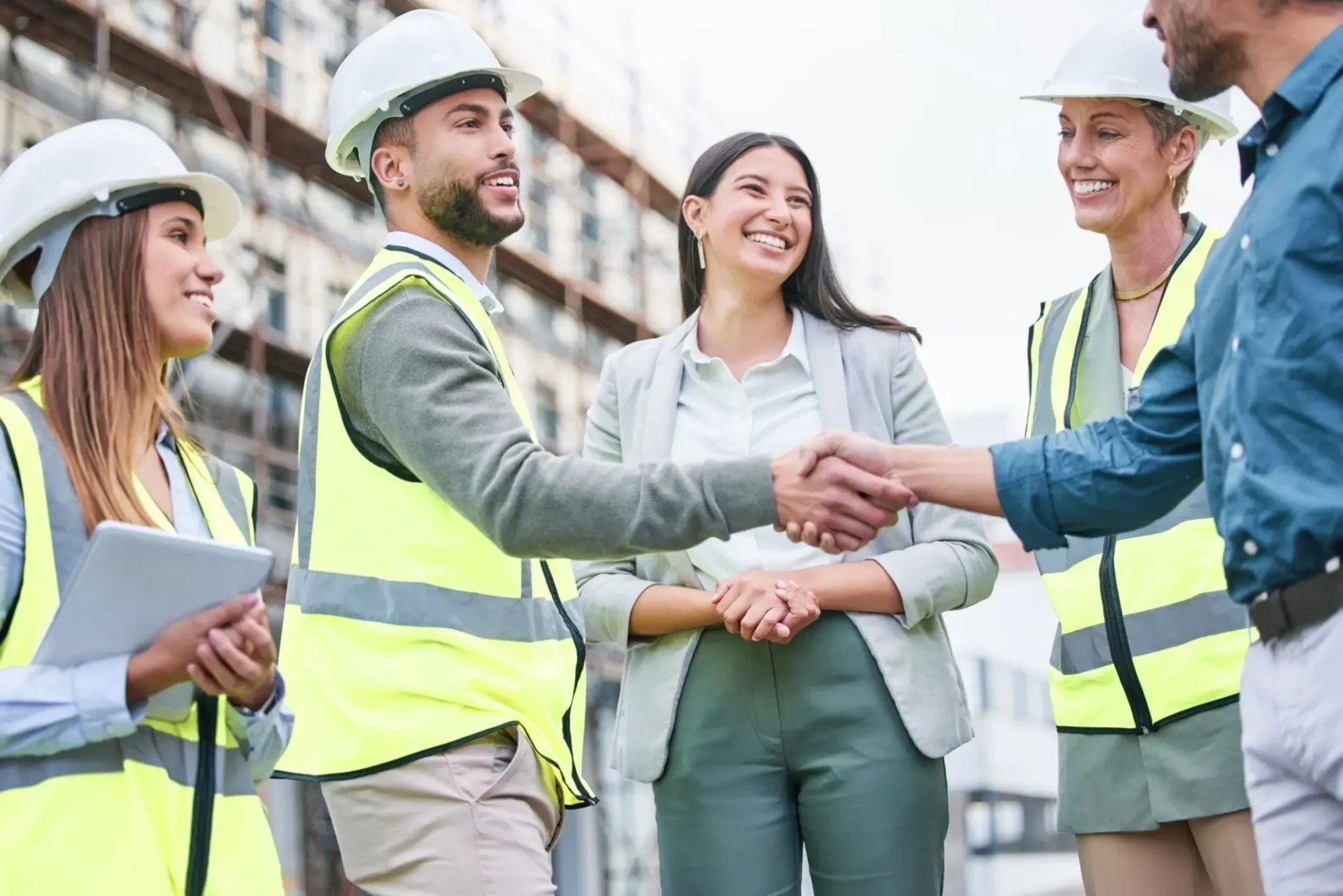 Construction team shaking hands on site.