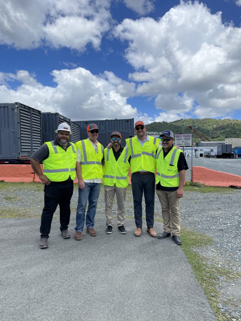 Group of workers in safety vests outdoors.